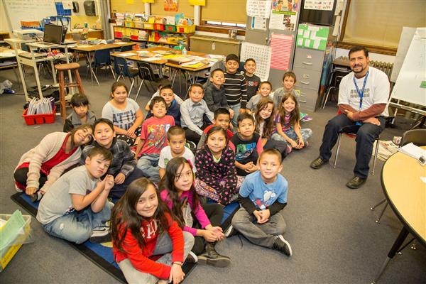 Students at Bryant Webster Dual Language School pose with their teacher. 
